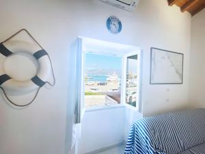 a bedroom with a bed and a window with a view at Casa Lo Chef - ArgonautiVacanze in Portoferraio