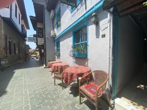 a row of tables and chairs on a street at Camel Hotel & Apart in Antalya
