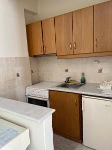 a kitchen with wooden cabinets and a sink at Peaceful House in Naxos Chora