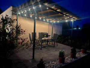 a patio with a table with lights on it at Haus Bernsteinsee mit Goitzsche-Schnuppersegeln in Friedersdorf