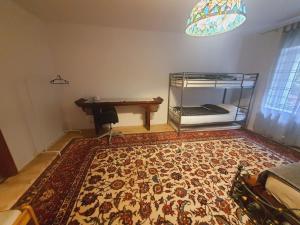 a room with a bed and a table and a rug at A cozy room near warsaw in Michałowice