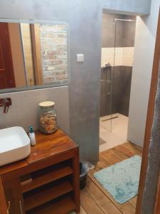 a bathroom with a sink and a shower with a mirror at A cozy room near warsaw in Michałowice