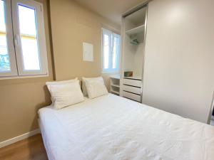 una camera da letto con un grande letto bianco con due cuscini di Palmela Downtown Terrace a Palmela