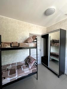 a bedroom with two bunk beds in a room at PitStop Motel in Kamianske