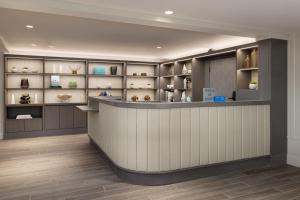 a lobby with a counter and shelves with vases at The Pell, Part of JdV by Hyatt in Middletown