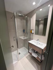 a bathroom with a sink and a shower at Hotel H4 Cangas 3 Superior in Cangas de Morrazo +37 photos