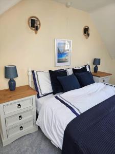 - une chambre avec 2 lits et une table de nuit avec des lampes dans l'établissement Bosun`s Cottage Luxury stay in the heart of town, à Weymouth