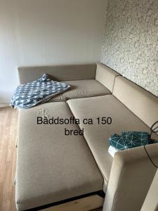 a brown couch in a living room with at Söt liten stuga för 2 in Strömstad