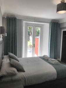 a bedroom with a large bed and a large window at Arrandale Guest House in Edinburgh
