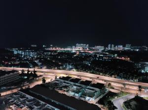 a view of a city at night with a freeway at MVISTA 3BR AirportView CozyStay in Bayan Lepas