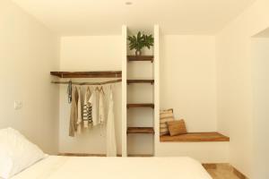 a bedroom with a white bed and a closet at La bergerie des petits loups in Montagnac-la-Crempse