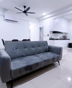 a couch in a living room with a ceiling fan at MVISTA 3BR AirportView CozyStay in Bayan Lepas