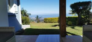 a view of a yard from a house with a patio at Cosy & Calme in Le Tampon