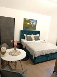 a bedroom with a bed and a table with a coffee table at Studios Merdović in Budva +62 photos