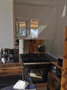 a kitchen with a stove and a counter top at Cosy & Calme in Le Tampon