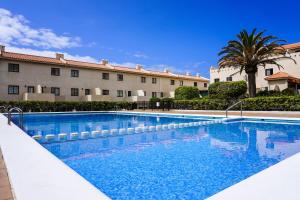 a large swimming pool in front of a building at Bright House, Pool & Workspace near Medano Beach in El Médano