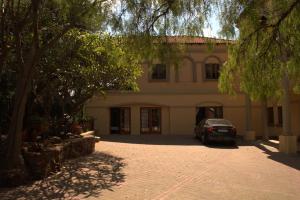 a car parked in front of a building at Aloha Lodge 2 Bedroom Apartment near Menlyn Sleeps 4 in Pretoria