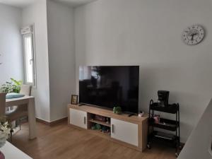 a living room with a large flat screen tv at RockSide Residences Suites La Línea A8 in La Línea de la Concepción