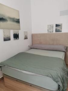 a bed in a bedroom with two pictures on the wall at RockSide Residences Suites La Línea A8 in La Línea de la Concepción