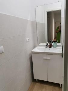 a white bathroom with a sink and a mirror at RockSide Residences Suites La Línea A8 in La Línea de la Concepción