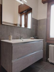 a bathroom with a sink and a mirror at Dudi Jolie Maison - Jacuzzi in Lezzeno +32 photos