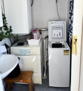 a small kitchen with a stove and a refrigerator at Unique holiday accommodation on Langholmen in Gothenburgs western archipelago in Torslanda