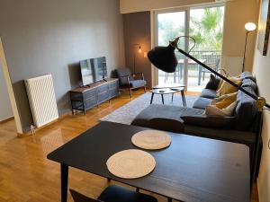 a living room with a couch and a table at Cozy Apartment with Scenic View in Athens