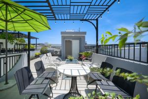 a patio with a table and chairs and an umbrella at Thanh Homestay Đà Nẵng gần sân bay và trung tâm thành phố in Danang