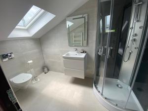 a bathroom with a toilet and a sink and a shower at Casa Marisa in Eforie Nord +26 photos