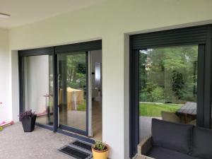 a living room with sliding glass doors at Villa LOE in Villach