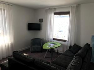 a living room with a couch and a table at La maison de Cécile in Ventron