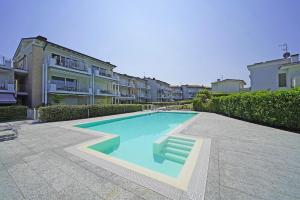 a swimming pool in front of some apartment buildings at La Castellana C89 by Wonderful Italy in Sirmione