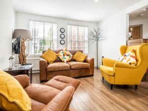 a living room with two couches and two chairs at Pass the Keys Stylish family home central Topsham with parking in Exeter