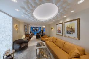 a living room with a couch and a large ceiling at Hallmark Hotel & SPA Istanbul in Istanbul
