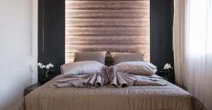 una camera da letto con un letto con una coperta e cuscini di Golden Island Resorts ad Atene