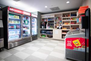 a store aisle with refrigerators and a soft drink refrigerator at Candlewood Suites Miami Intl Airport - 36th St, an IHG Hotel in Miami