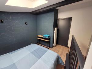 a bedroom with a large bed and a staircase at Duplex Mon Désert - Parc Sainte Marie - Nancy Thermal in Nancy