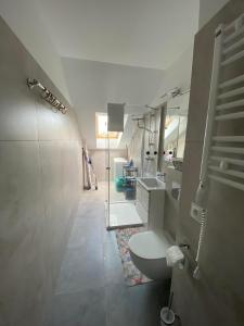 a bathroom with a toilet and two sinks at NATURAvistaMARE I in Dziwnów +16 photos
