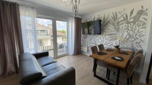 a living room with a couch and a table at NATURAvistaMARE I in Dziwnów