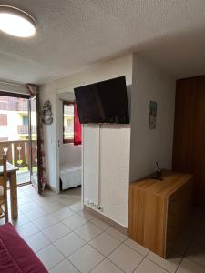 a living room with a flat screen tv on a wall at L'Épicéa - Praz in Praz-sur-Arly