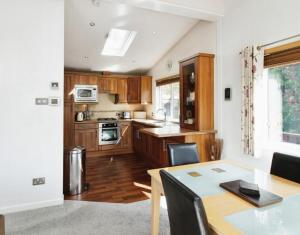 a kitchen with a table and a dining room at 10 Trehawks in Wadebridge