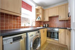 a kitchen with a washer and a dishwasher at Perfect City Centre Location - Historic Albion Mews in Chester +8 photos