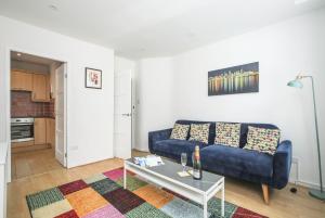 a living room with a blue couch and a table at Perfect City Centre Location - Historic Albion Mews in Chester