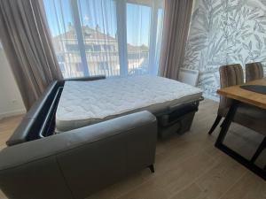 a bed in a room with a large window at NATURAvistaMARE I in Dziwnów