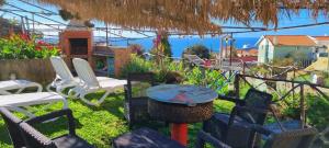 a group of chairs and a table in a yard at Villa Catanho in Funchal