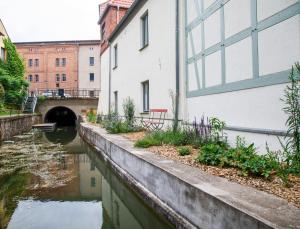 a canal in a city with buildings and a tunnel at Sommerfrische Lychen in Lychen