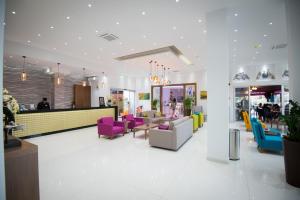 a lobby with colorful chairs and a counter at Loutsiana Deluxe Apts in Ayia Napa