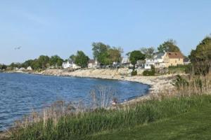 a body of water with houses in the background at Cozy 2 bedroom home w/Lake View in Lorain