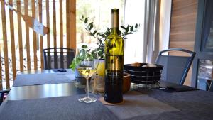 a bottle of wine sitting on a table with a glass at Lucas Mobile Home - premium mobile home with terrace and patio in Drage +52 photos