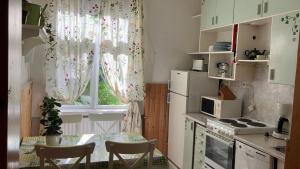a kitchen with a table and a window with curtains at VILLA ANNA in Naantali +5 photos
